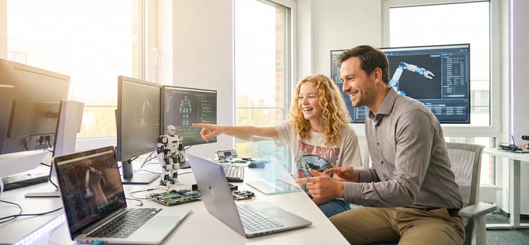 An Integem student working on a robotics project with an instructor